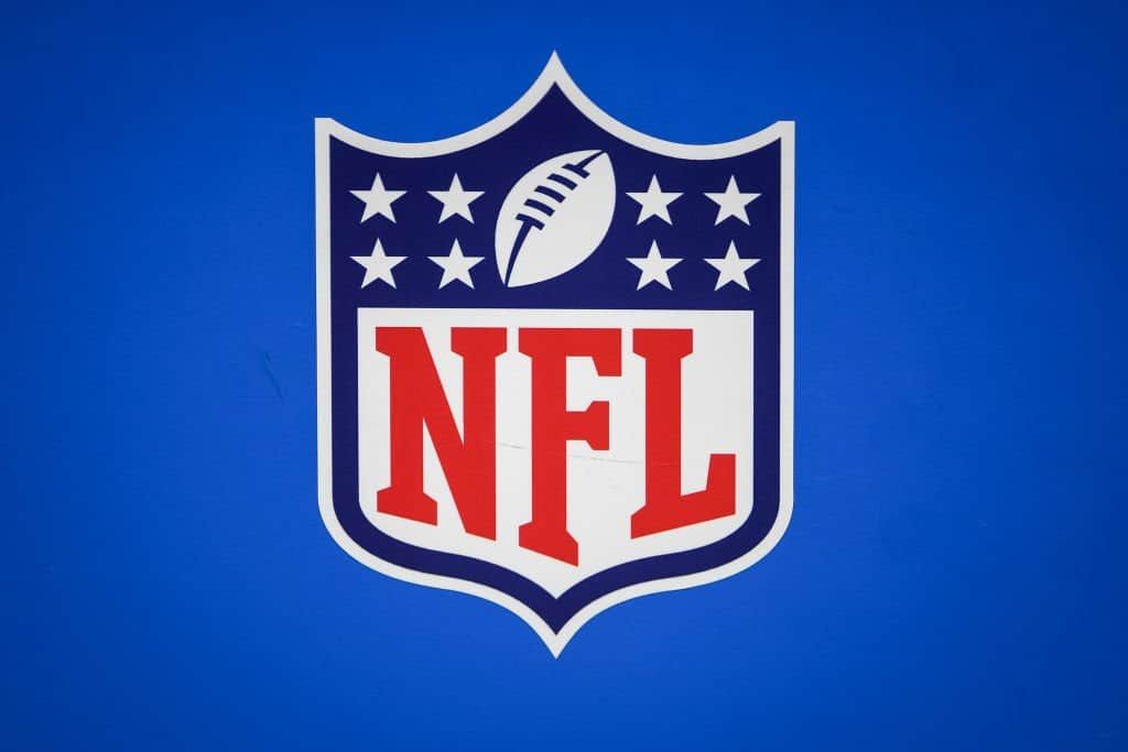 A photo of the NFL logo shield on a blue background.