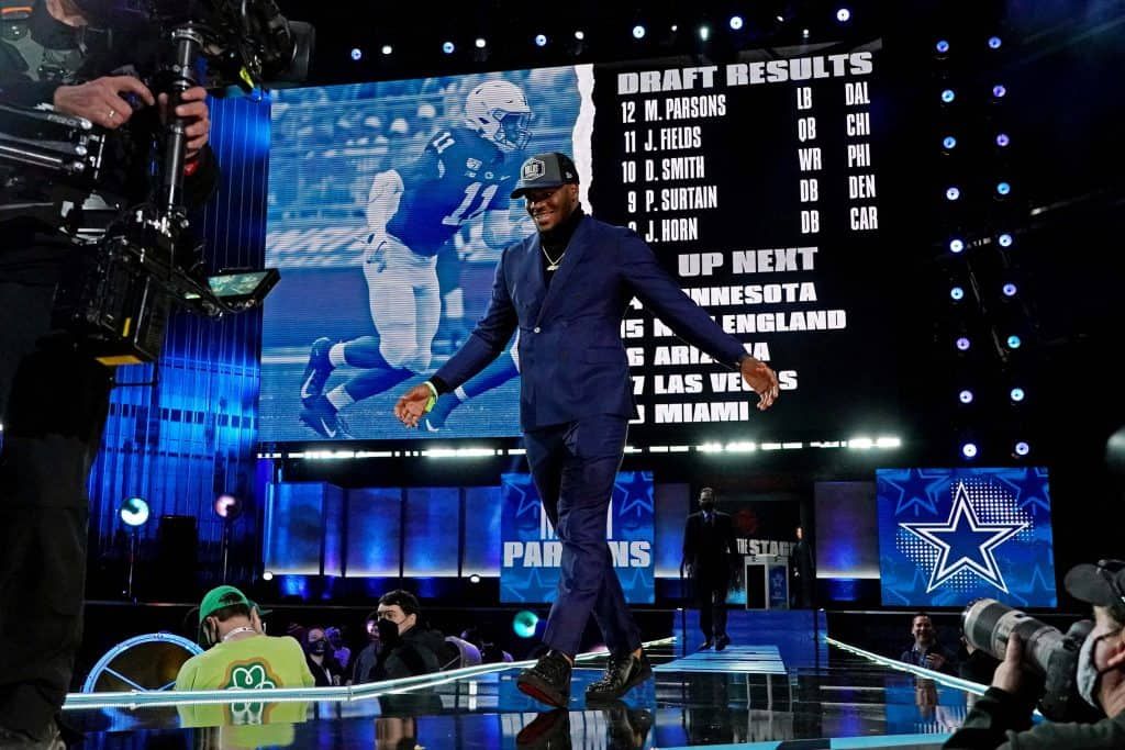 Micah Parsons walks across the 2021 NFL Draft stage following his selection via the Dallas Cowboys