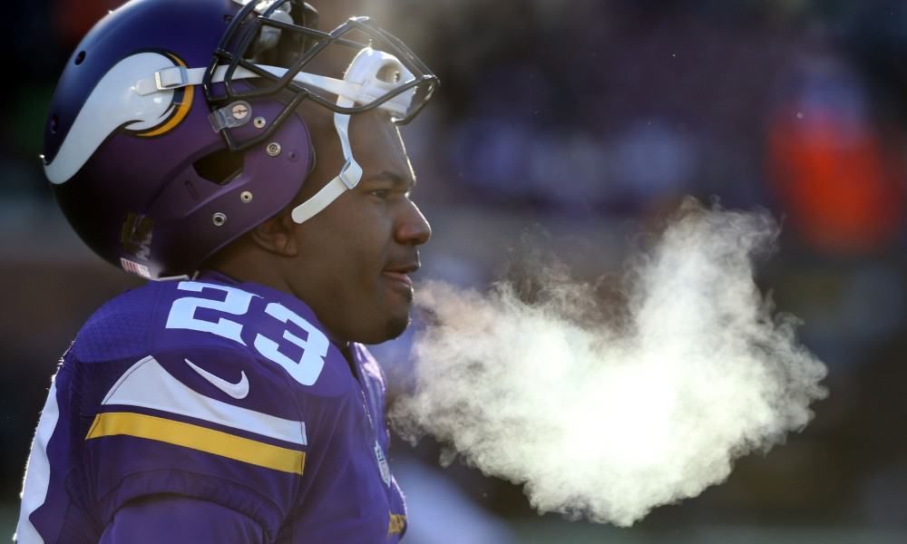 A Minnesota Vikings player breathes out cold air during a game.