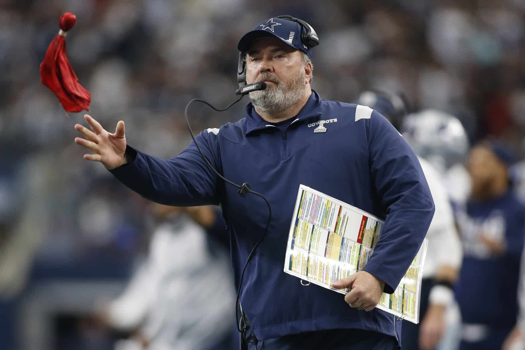 Dallas Cowboys head coach Mike McCarthy throws a challenge flag.