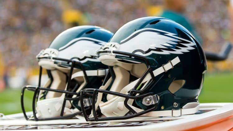 Two Philadelphia Eagles helmets pictured on the team's bench.