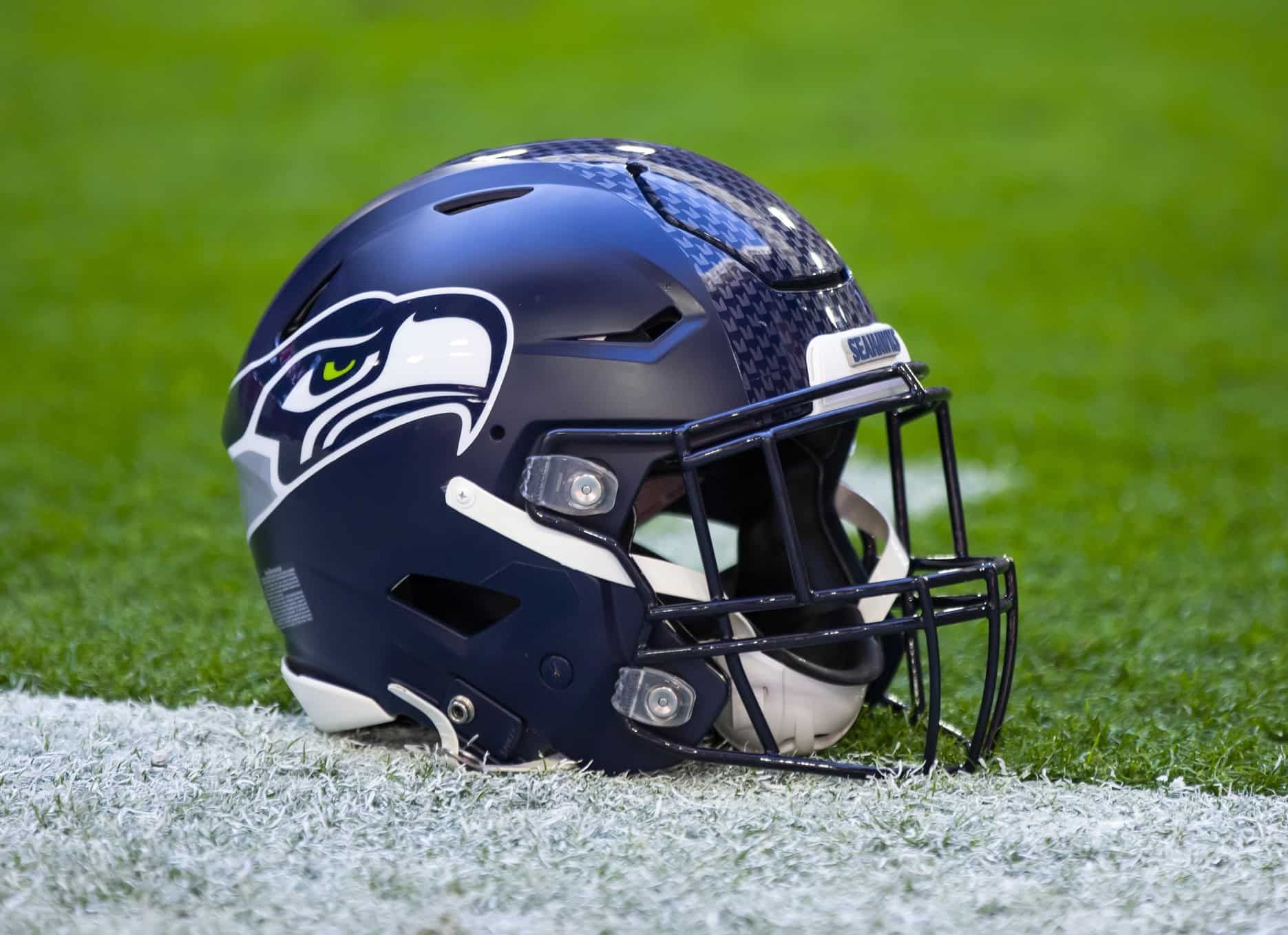 The helmet of the Seattle Seahawks displayed at the edge of the sidelines at State Farm Stadium.