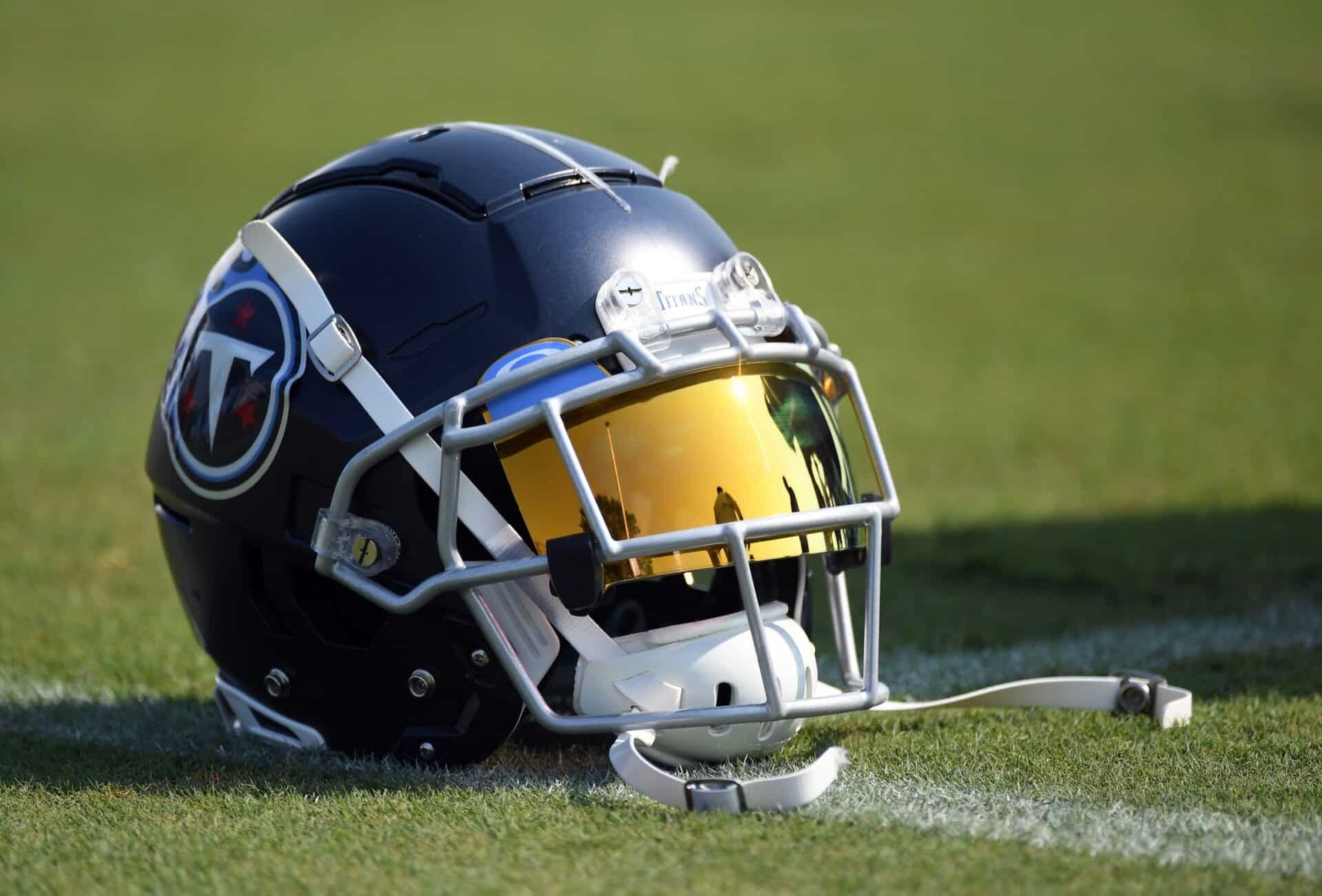 A Tennessee Titans helmet sits in the grass during stretching time at training camp.