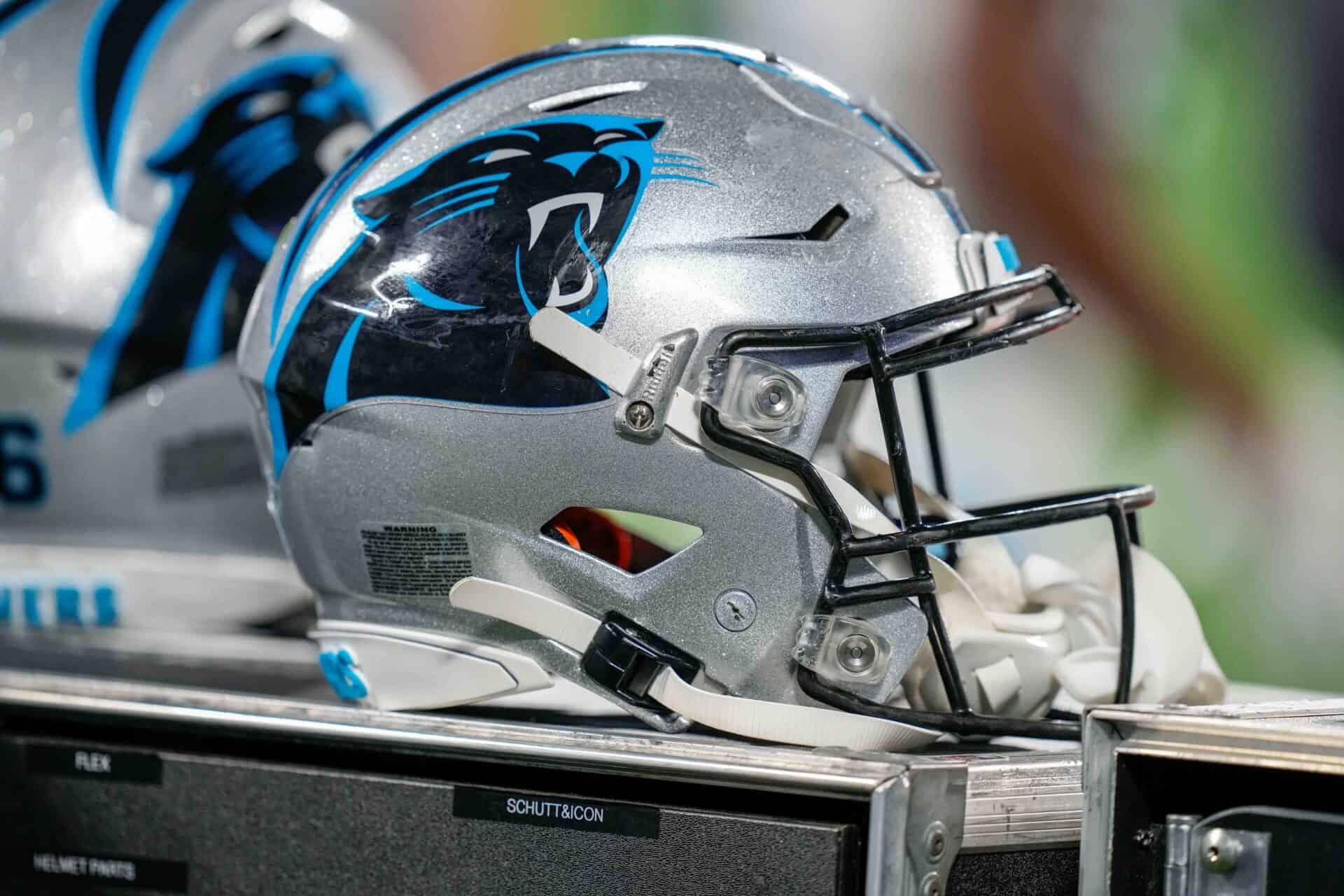 A close-up look of the Carolina Panthers helmet displayed on the bench of the sidelines.