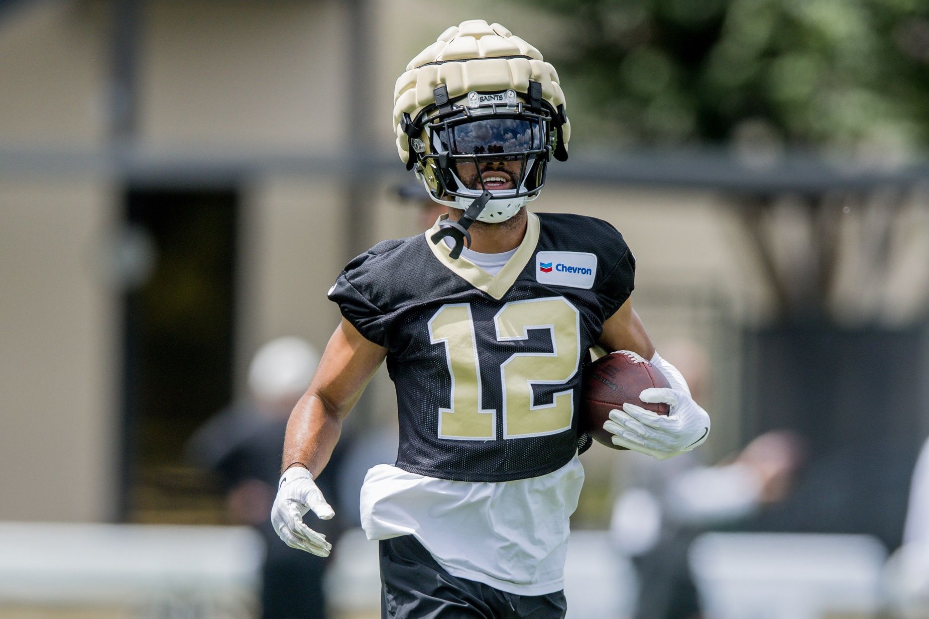 New Orleans Saints WR Chris Olave (12) running drills during minicamp.