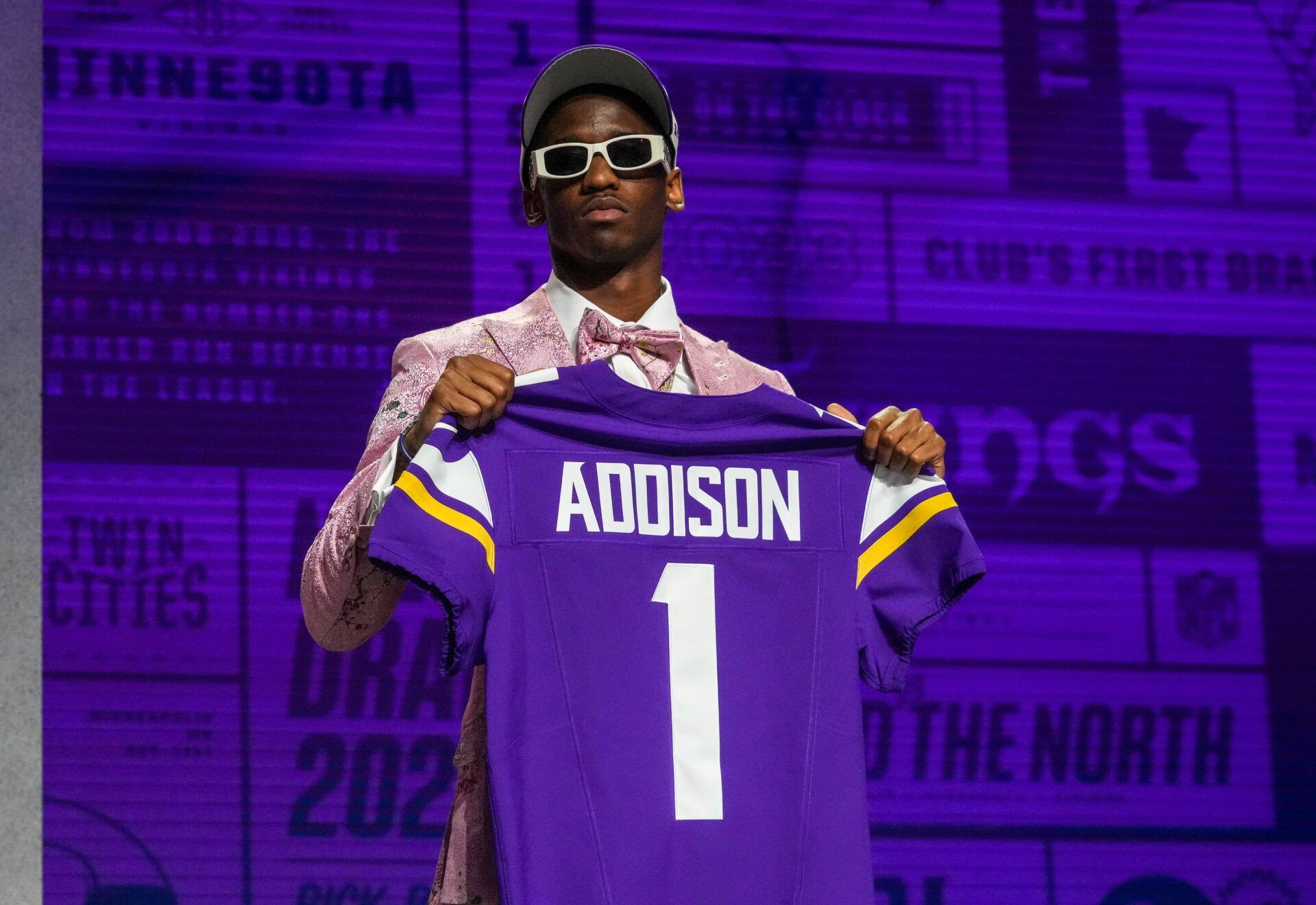 Minnesota Vikings WR Jordan Addison posing for pictures with his jersey at the 2023 NFL Draft.