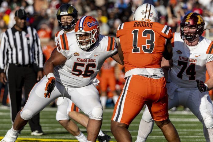 O'Cyrus Torrence of Florida and offensive lineman John Michael Schmitz of Minnesota block against National defensive lineman Karl Brooks of Bowling Green.