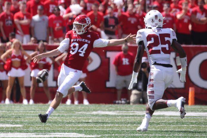 Rutgers kicker Adam Korsak (94) punts the ball against Temple.