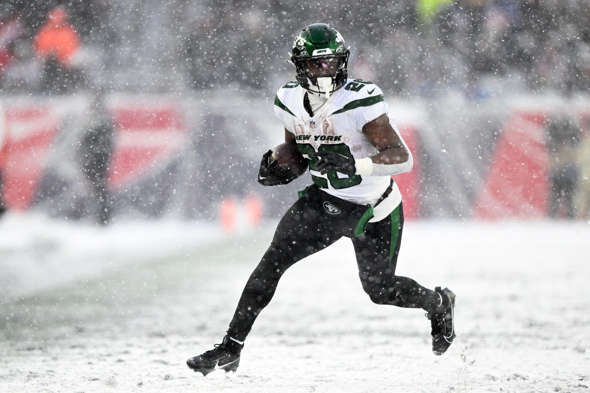 New York Jets running back Breece Hall (20) runs against the New England Patriots during the second half at Gillette Stadium.