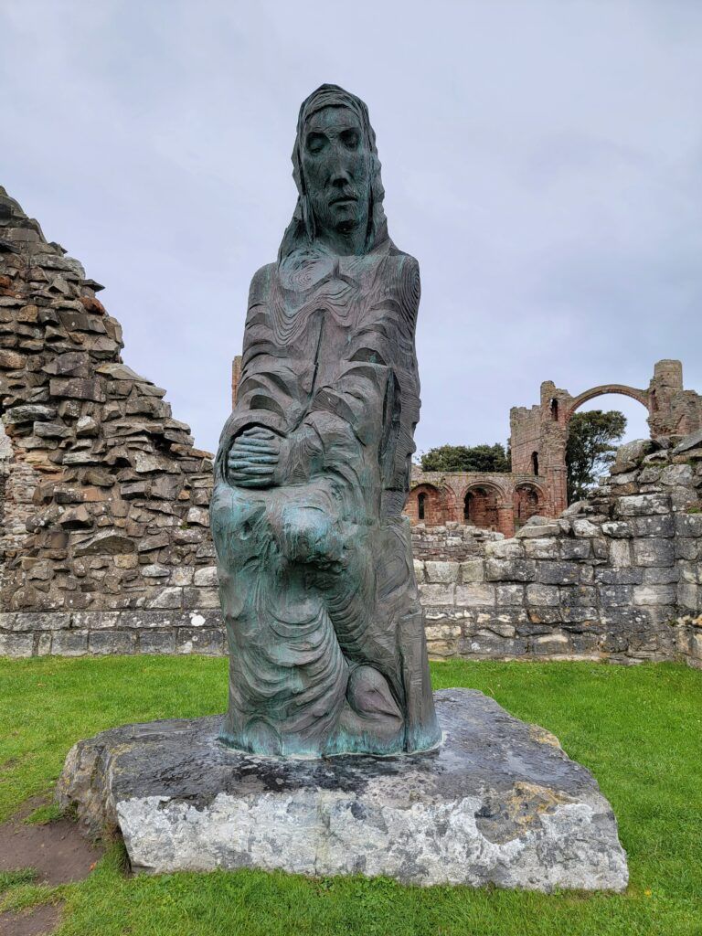 Statue of St. Cuthbert at the ruins of Lindisfarne Priory