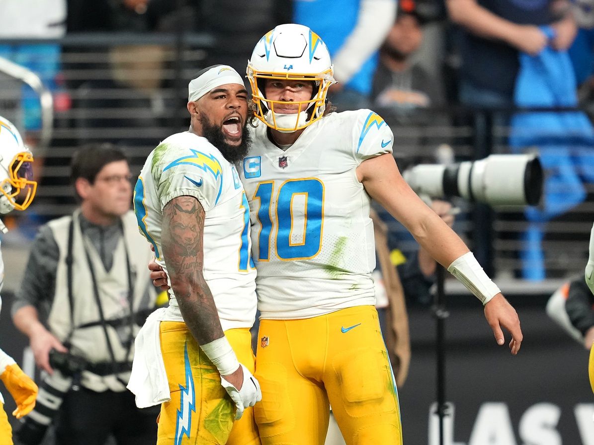 Los Angeles Chargers wide receiver Keenan Allen (13) celebrates with Los Angeles Chargers quarterback Justin Herbert (10) after scoring a touchdown against the Las Vegas Raiders during the second half at Allegiant Stadium.