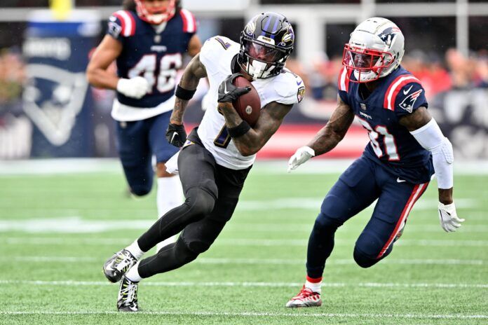 Rashod Bateman (7) runs with the ball in front of New England Patriots cornerback Jonathan Jones (31) during the second half at Gillette Stadium.