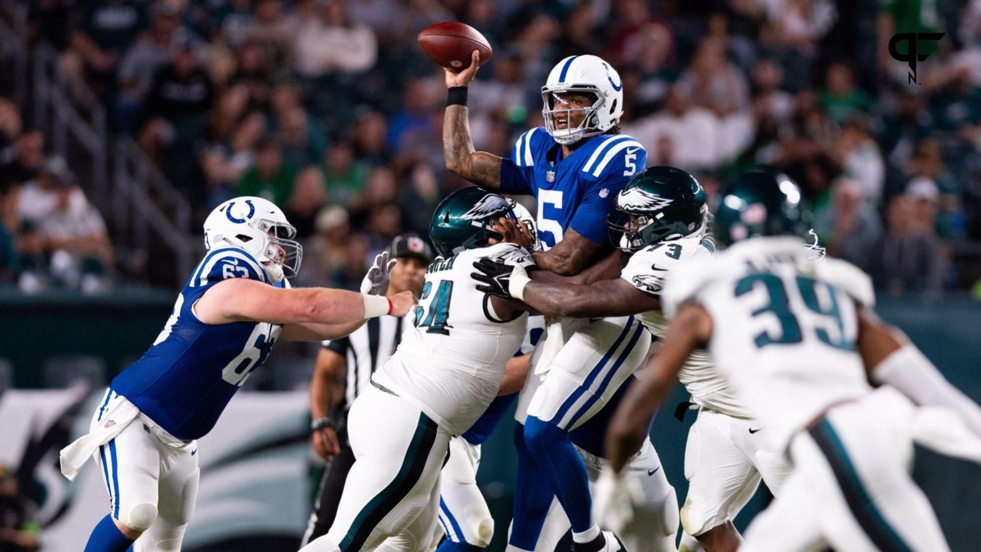 Indianapolis Colts quarterback Anthony Richardson (5) passes the ball while being hit by Philadelphia Eagles defensive tackle Marvin Wilson (73) and defensive tackle Robert Cooper (64) during the second quarter at Lincoln Financial Field.