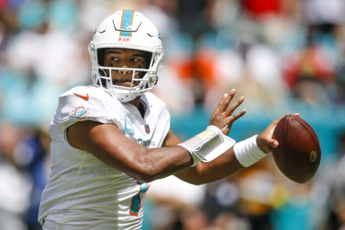 Tua Tagovailoa winds up to throw against the Patriots.