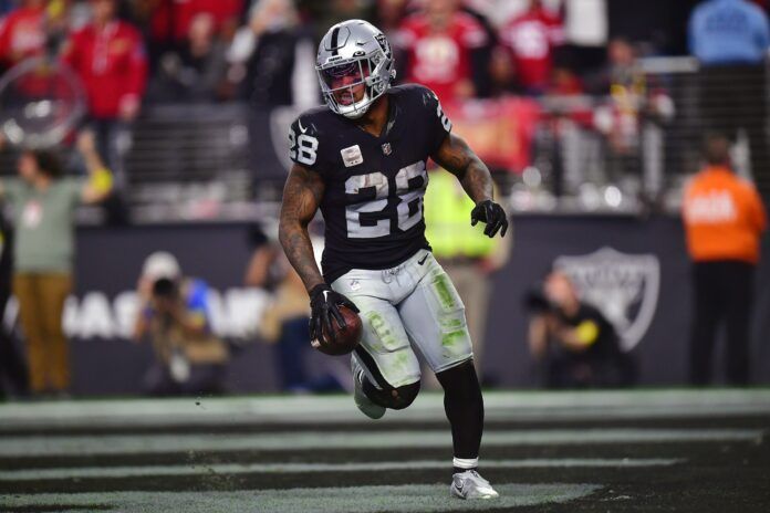 Josh Jacobs celebrates after scoring a touchdown against the 49ers.