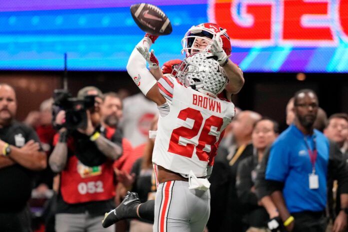 Ohio State cornerback Cameron Brown (26) breaks up a pass intended for Georgia wide receiver Ladd McConkey (84) during the Peach Bowl.