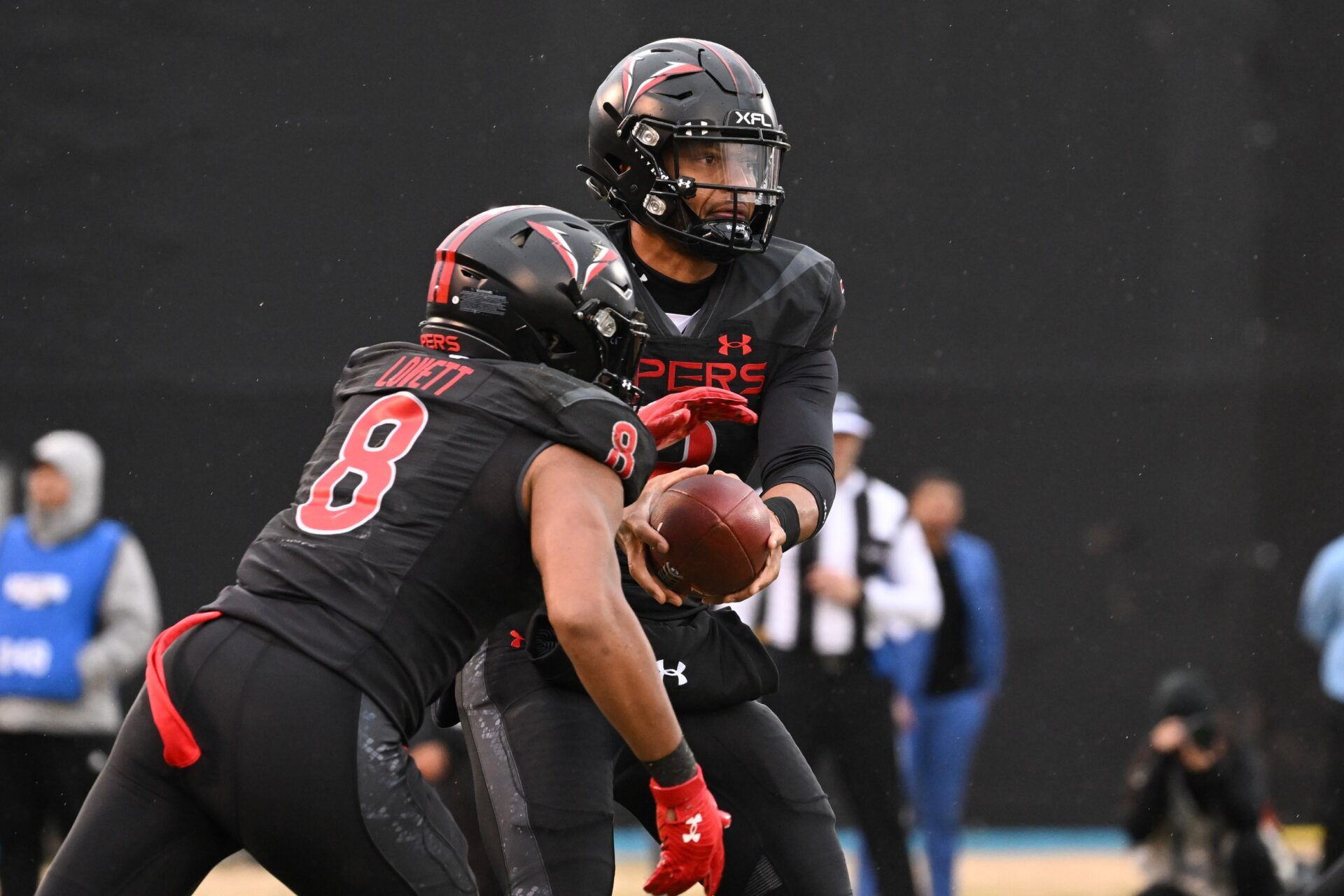 Vegas Vipers quarterback Brett Hundley (2) hands the ball off to running back John Lovett (8) against the D.C. Defenders in the first quarter at Cashman Field.