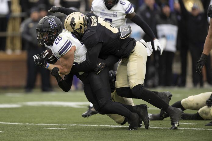 Purdue LB Jalen Graham (6) tackles Northwestern RB Evan Hull (26).