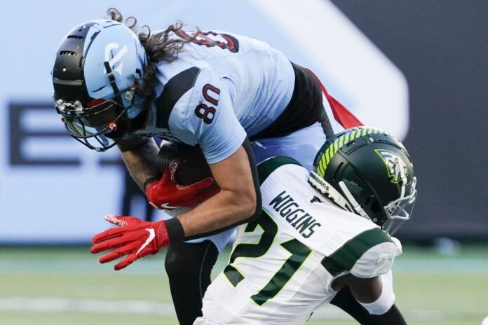 Arlington Renegades TE Sal Cannella (80) is tackled by Guardians DB Shaquille Wiggins (21).