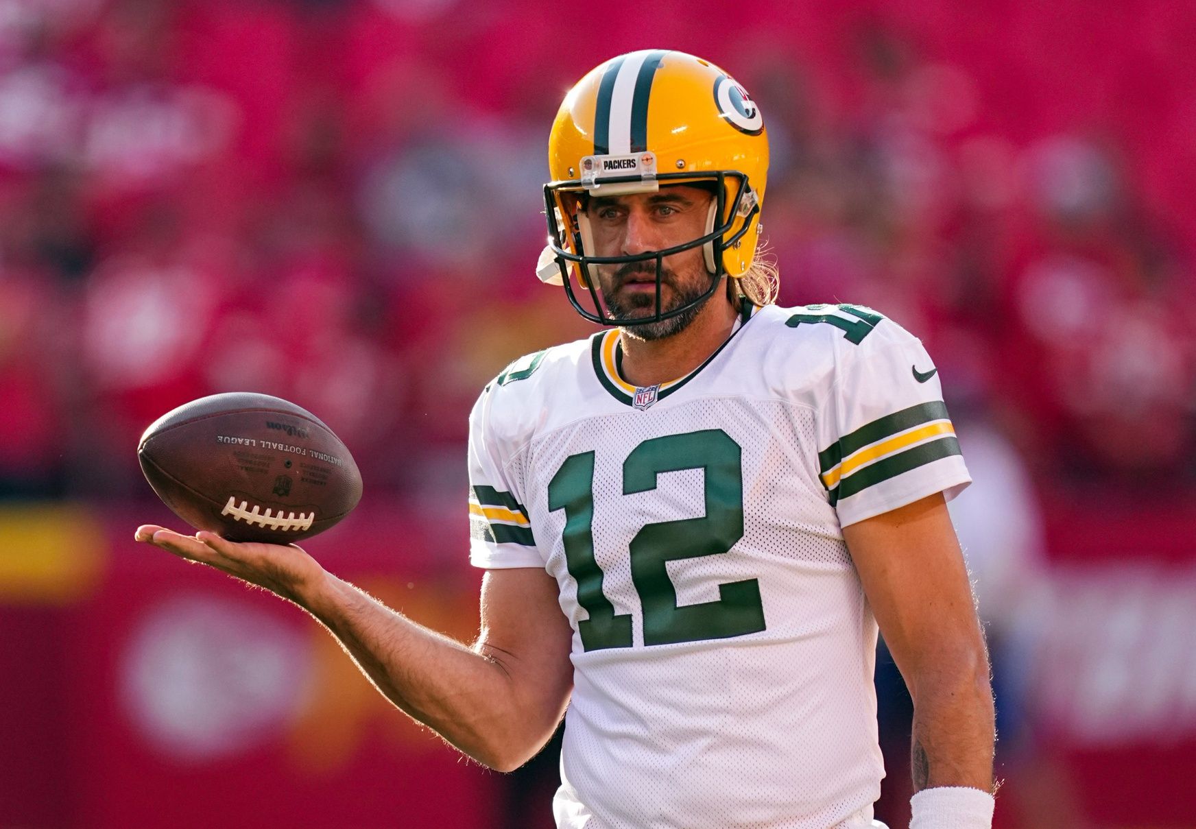 Aaron Rodgers warms up before a game against the Kansas City Chiefs.