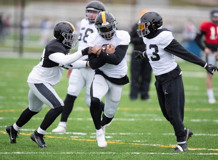 USFL Pittsburgh Maulers players practice at the Pro Football Hall of Fame.