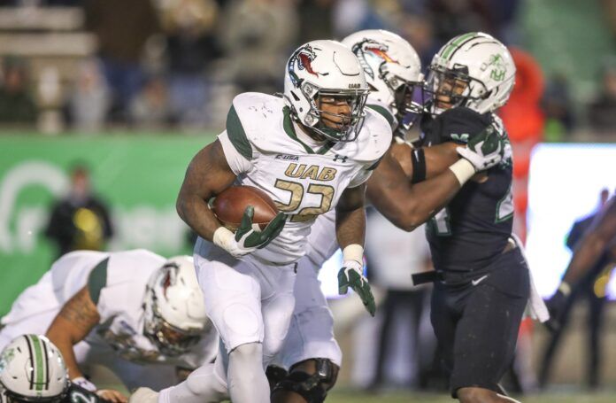 DeWayne McBride runs the ball against the Marshall Thundering Herd.