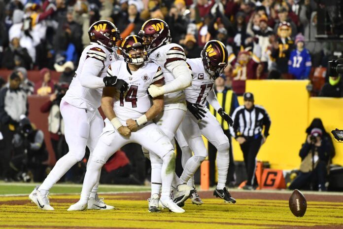 Washington Commanders QB Sam Howell celebrates a touchdown.