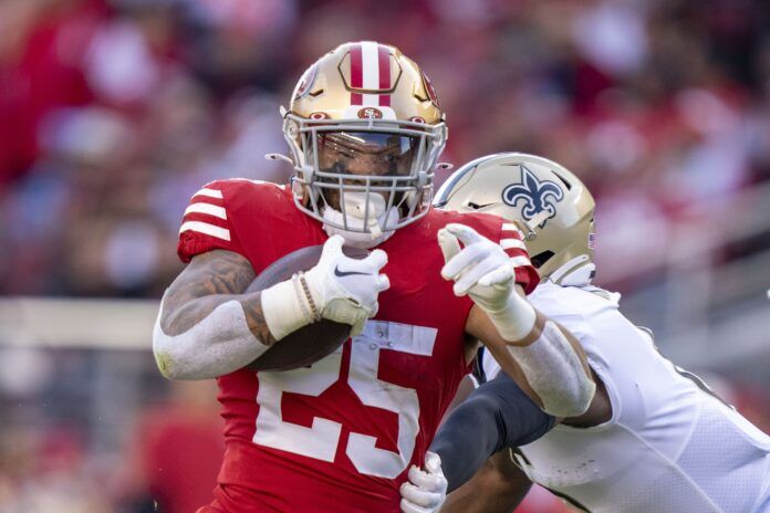 RB Elijah Mitchell shakes off a New Orleans Saints defender.