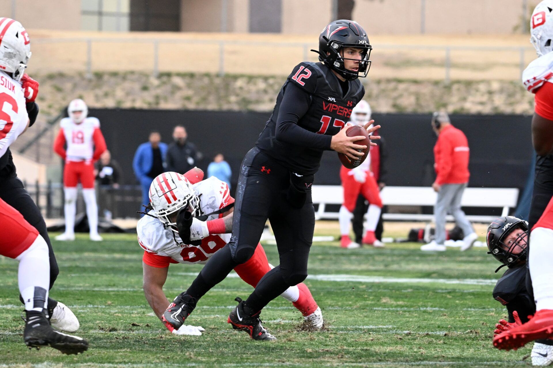 Vegas Vipers QB Luis Perez (12) avoids a tackle against the Defenders.