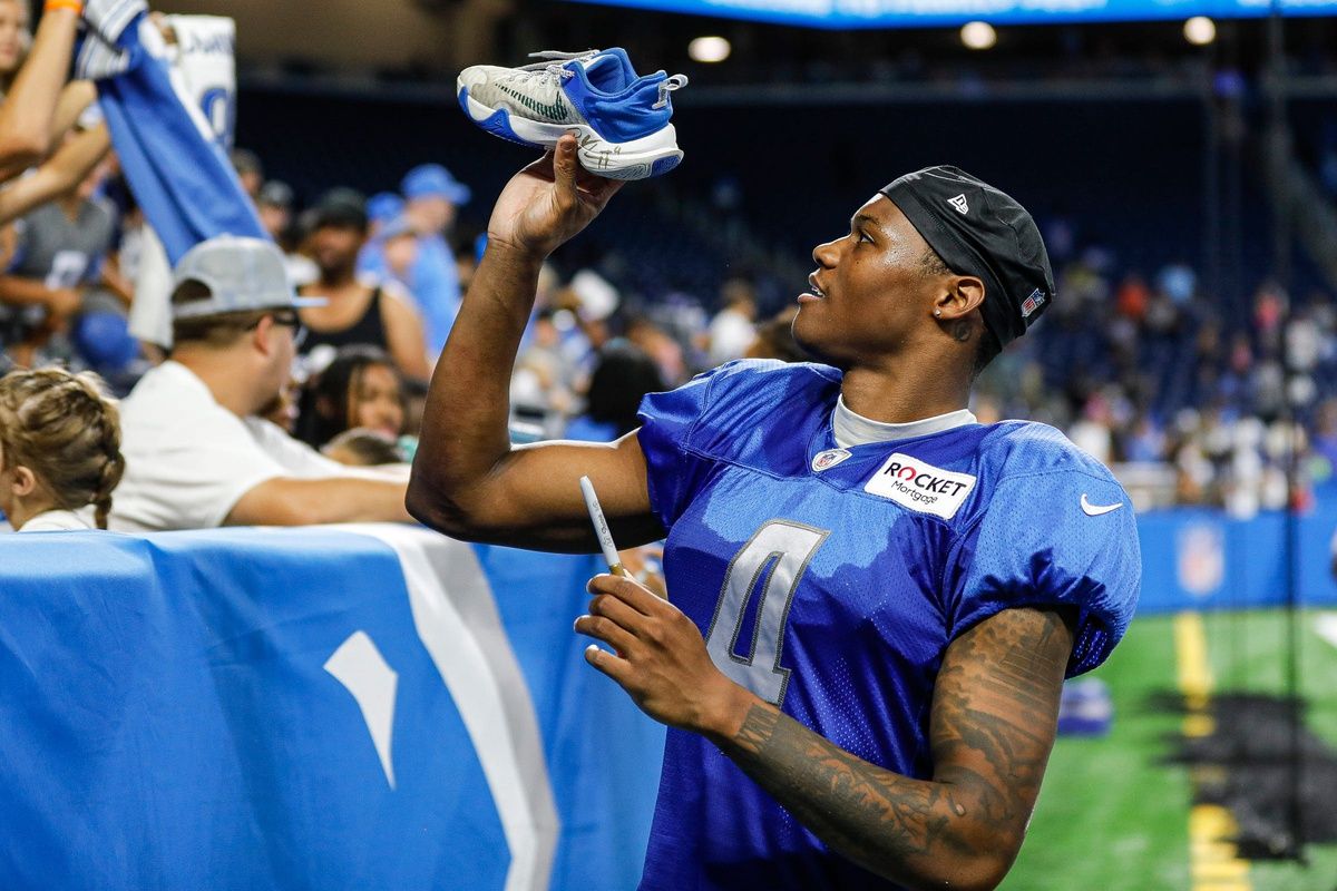 DJ Chark signs autographs for fans after open practice at Family Fest at Ford Field.