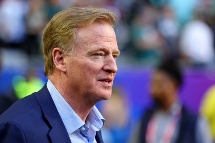 Roger Goodell walks on the sideline before Super Bowl LVII at State Farm Stadium.