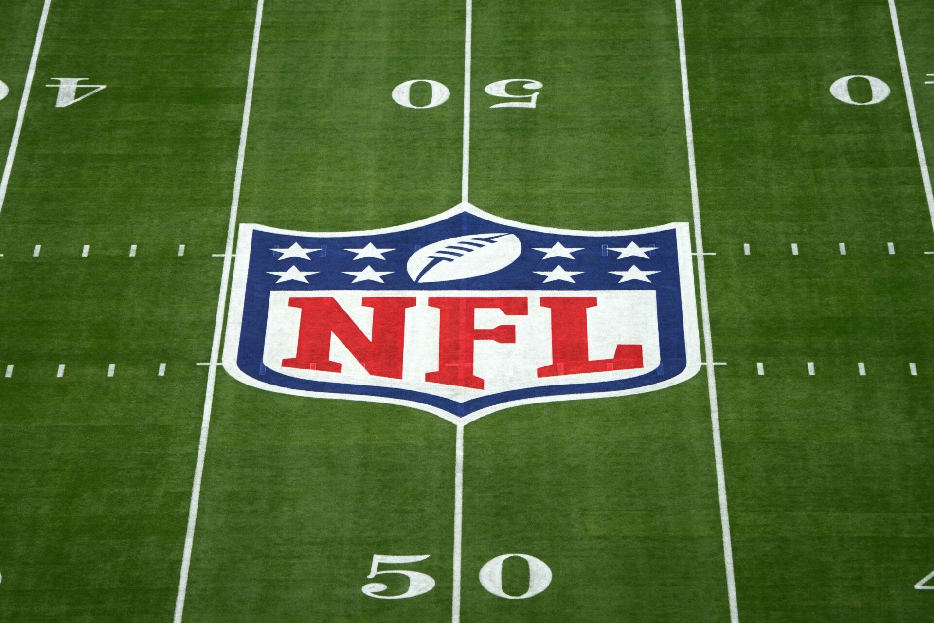 NFL logo on a football field.