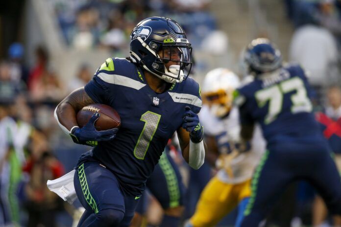 D'Wayne Eskridge runs the ball against the Los Angeles Chargers.