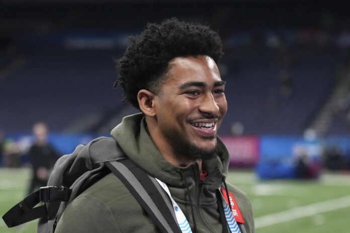 Alabama QB Bryce Young talking and smiling during the NFL Combine.