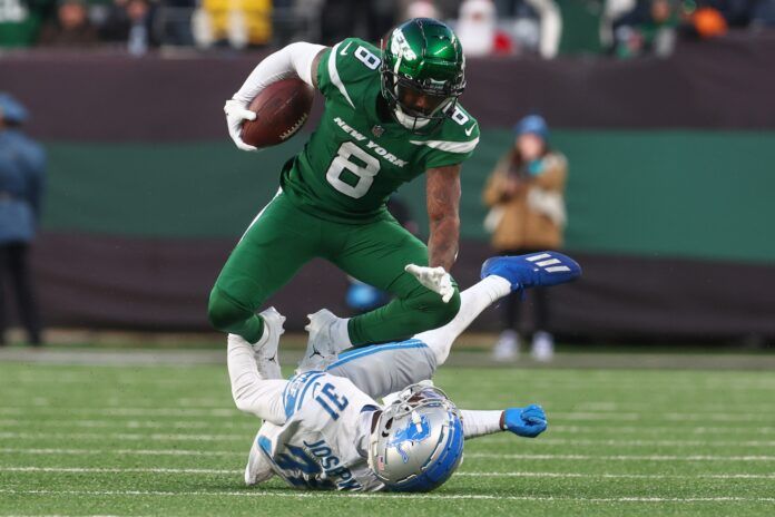 New York Jets WR Elijah Moore (8) runs over a Lions defender.