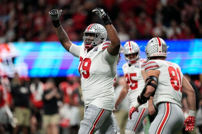 Ohio State offensive tackle Dawand Jones (79) celebrates a touchdown scored.