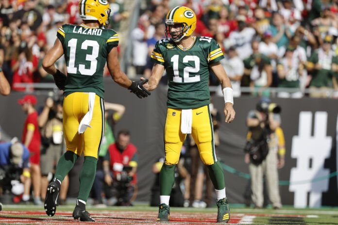 Green Bay Packers QB Aaron Rodgers (12) and WR Allen Lazard (13) congratulate each other during the game.