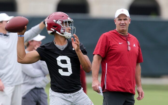 Bill O'Brien watches quarterback Bryce Young throw during practice.