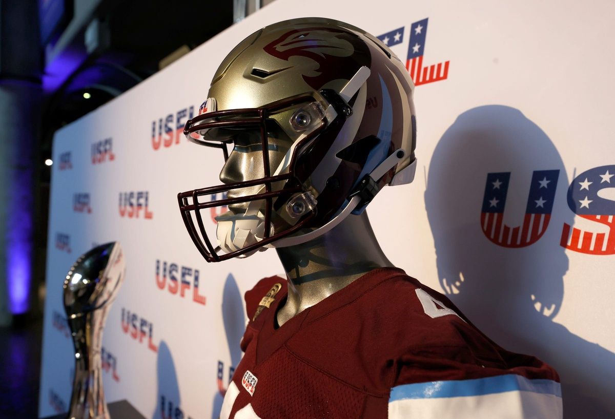 The USFL Michigan Panthers and the championship trophy on display during a press conference.