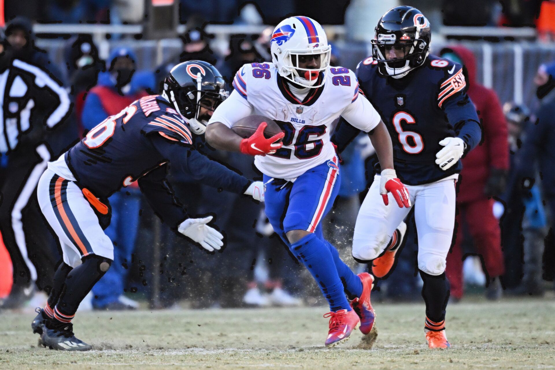 Running back Devin Singletary takes on two Chicago Bears defenders.