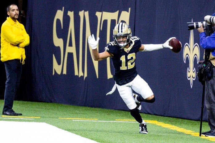 New Orleans Saints WR Chris Olave (12) happily reacts after scoring a touchdown.