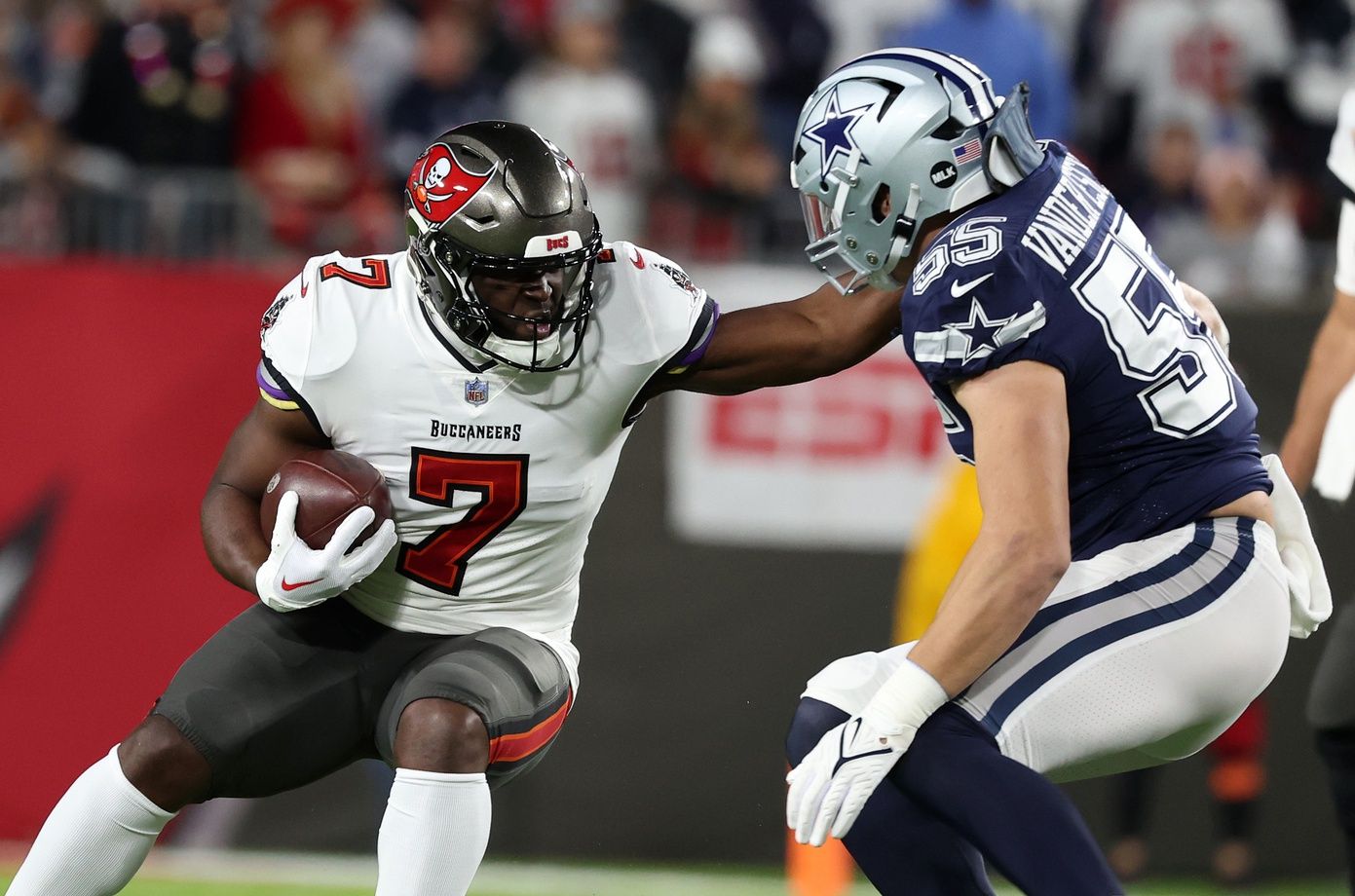 Tampa Bay Buccaneers RB Leonard Fournette (7) looks to break a tackle against Dallas' Leighton Vander Esch (55).