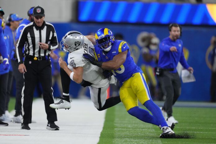 Los Angeles Rams LB Bobby Wagner (45) tackles Derek Carr (4) out of bounds.