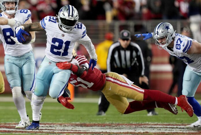 Dallas Cowboys RB Ezekiel Elliott (21) breaks a tackle against the 49ers.