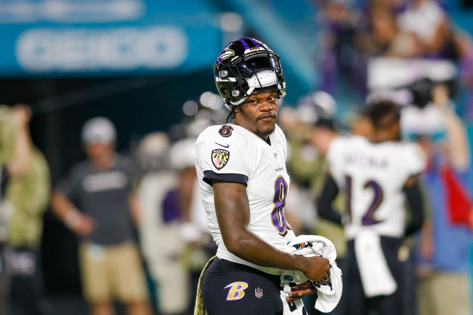 Lamar Jackson looks on from the field prior the game against the Miami Dolphins.