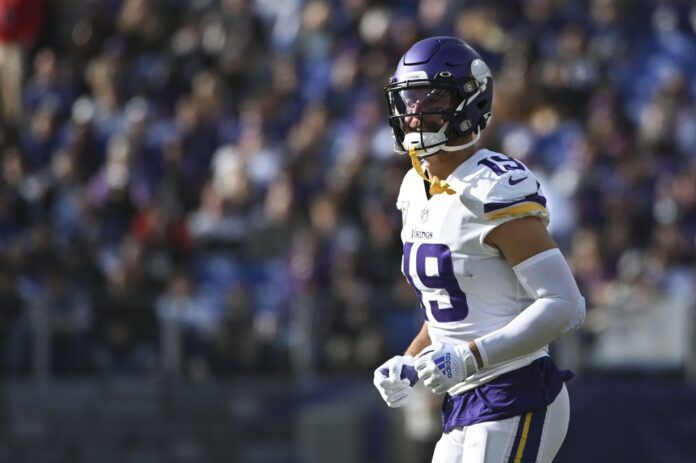 Adam Thielen runs on the field during the first half against the Baltimore Ravens.