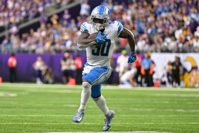 Jamaal Williams runs the ball during the game against the Minnesota Vikings.