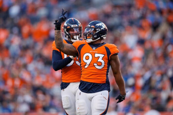 Denver Broncos defensive ends Dre'Mont Jones (93) and Bradley Chubb (55) celebrate.