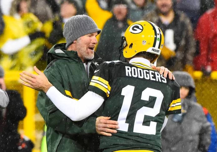 Brett Favre and Aaron Rodgers greet each other before the Green Bay Packers hit the field.