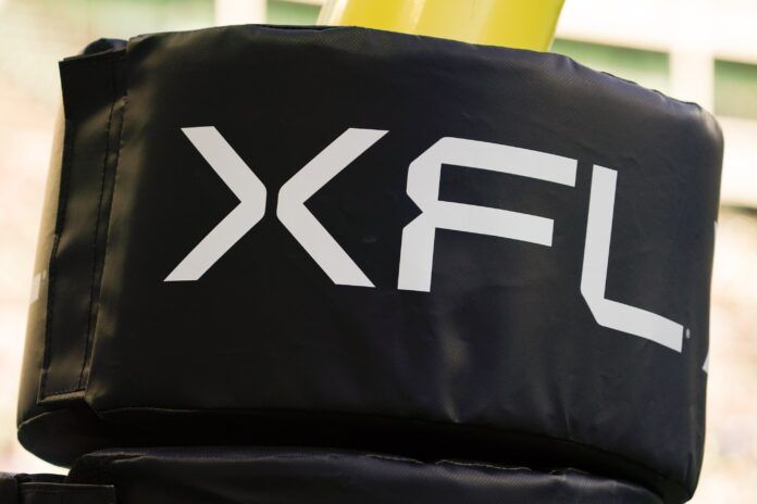 The XFL logo on a goal post during a game.